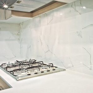 Stylish kitchen interior featuring decorative candles and orchids on a countertop.