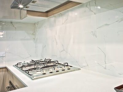 Stylish kitchen interior featuring decorative candles and orchids on a countertop.